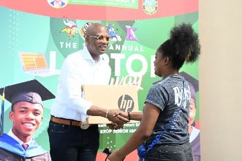 Chairman Oliver G. Gilbert giving away laptop to high school student