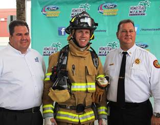 Homestead-Miami Speedway President Matthew Becherer; NASCAR driver Carl Edwards; and Miami-Dade Fire Rescue Fire Chief David Downey at Miami-Dade Fire Rescue Headquarters training facility on Wednesday, September 11, 2013