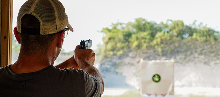 A male at Trail Glades Range shooting at a target.