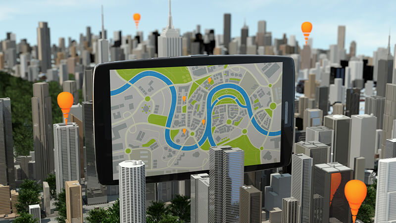 image of a GIS application on a tablet hovering over a city skyline