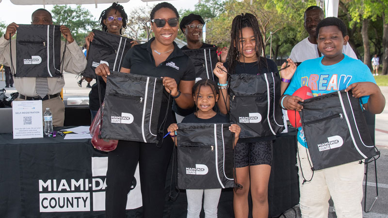 Group of people holding swag from a fair.